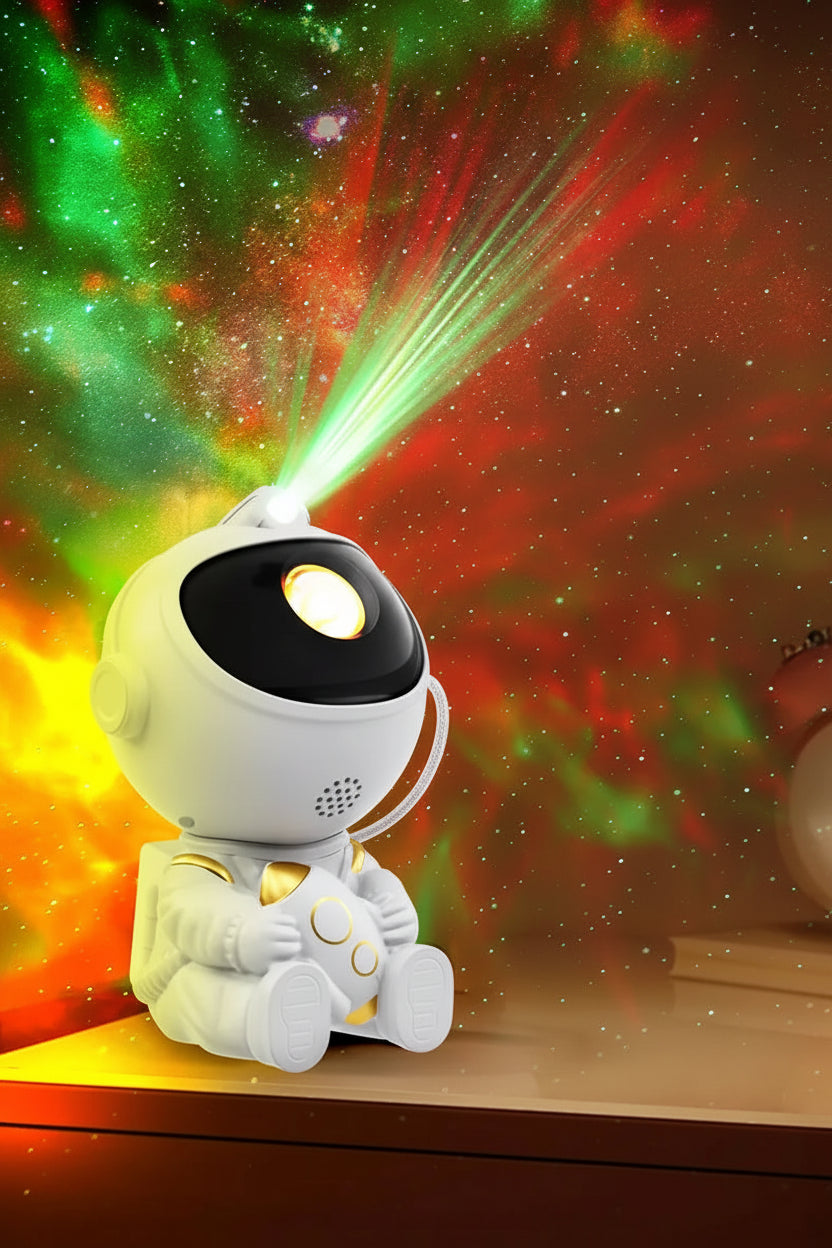 Astronaut-shaped projector with 360-degree rotation and built-in magnetism on a colorful galaxy background.