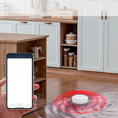 Smart water leak sensor placed under washing machine detecting flood instantly