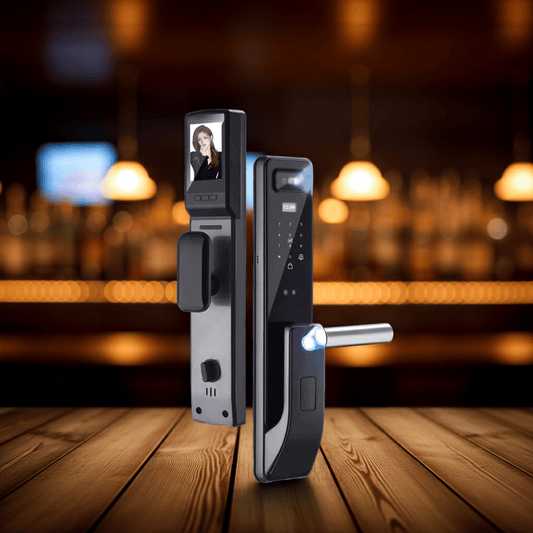 Two modern smart lock entry devices displayed on a wooden table with a blurred bar interior in the background. One device shows a front-facing screen with a person visible, and the other shows the side with a silver handlebar illuminated by a blue light.