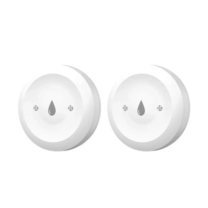 Two white round devices with a ZigBee logo on a white background