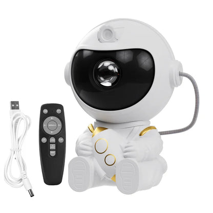 White robot toy with black face and gold accents, accompanied by a remote control and USB cable on a white background.