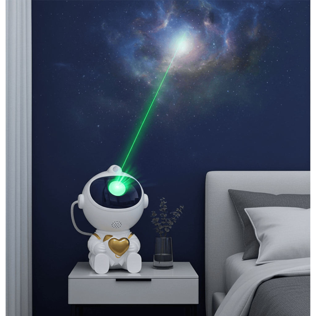 A white astronaut-shaped night light with a glowing green laser projecting a galaxy onto a dark blue bedroom wall, shown beside a bed and bedside table.